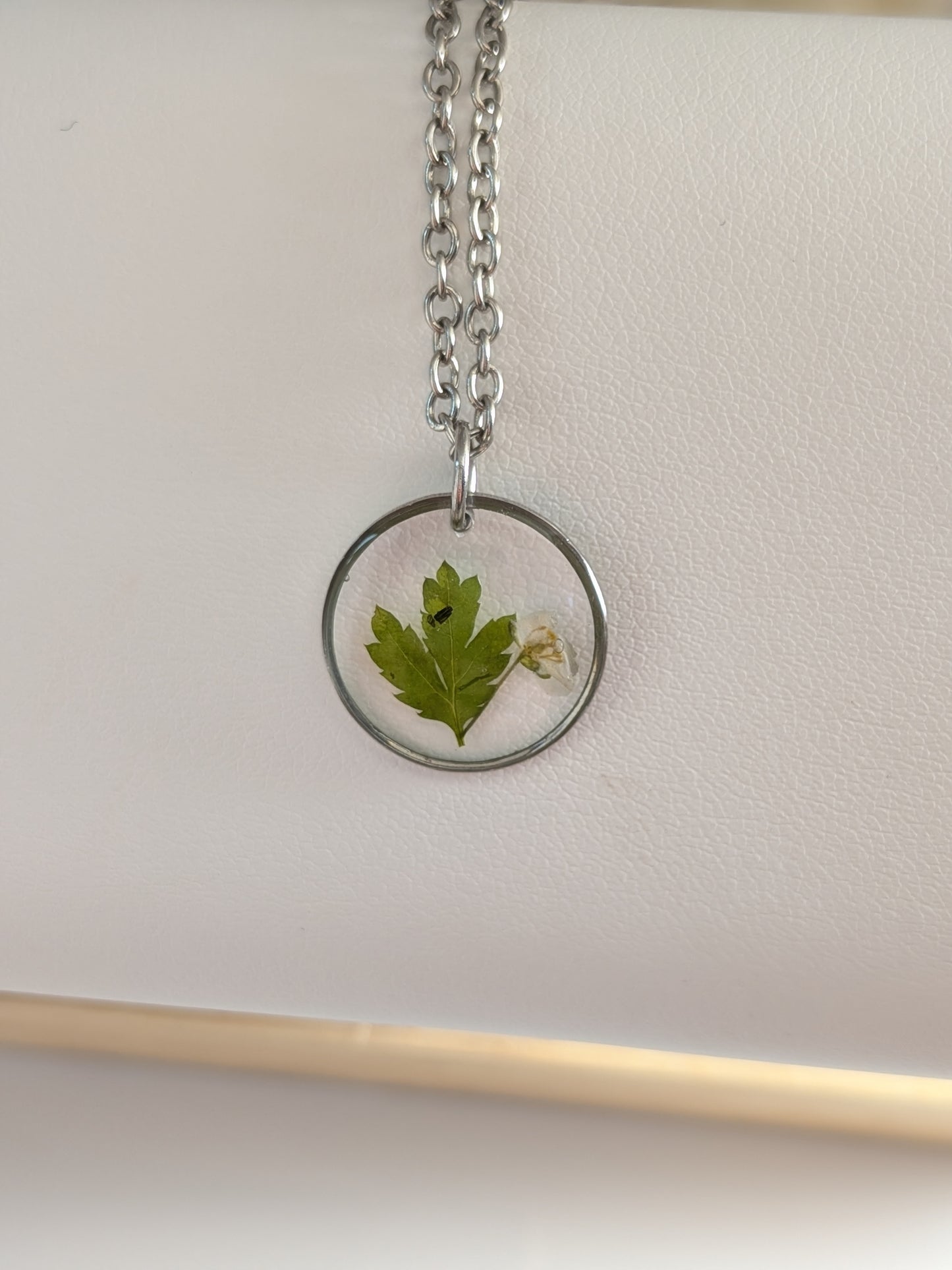 White flower with greenery