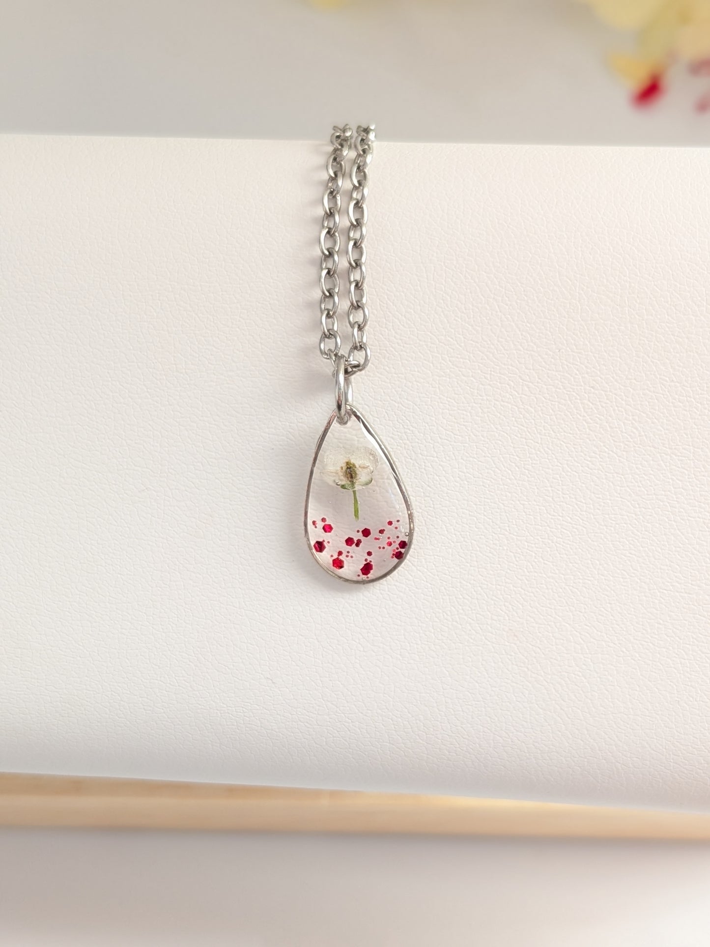 Red glitter, white floral teardrop