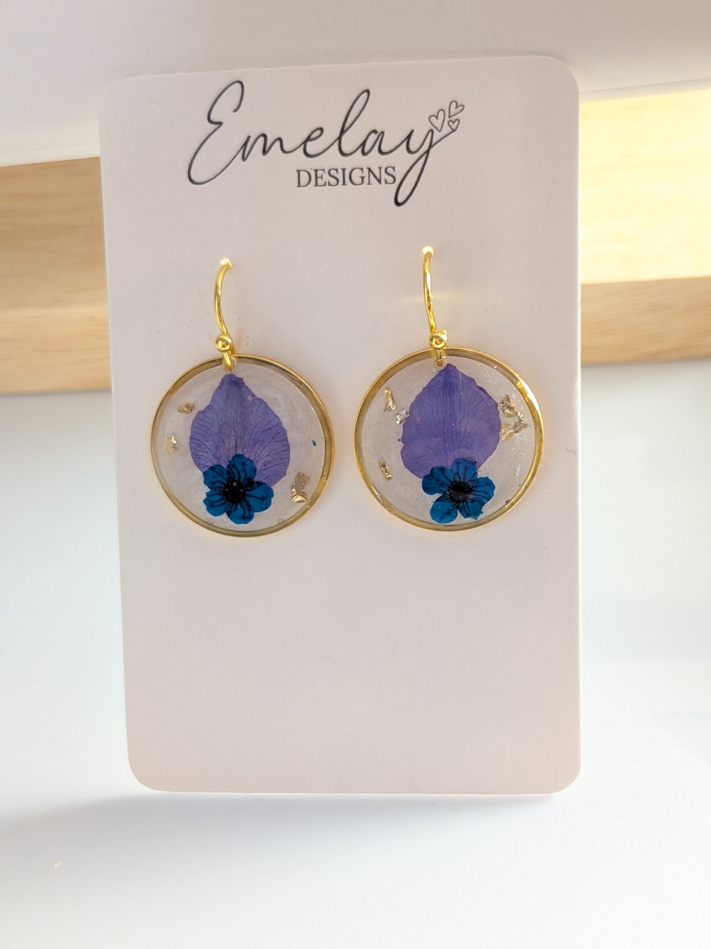 Floral pendants with white background earrings.